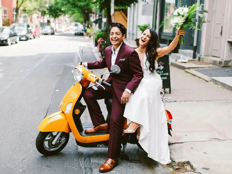 Brides on scooter after wedding