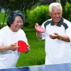Older couple playing ping pong