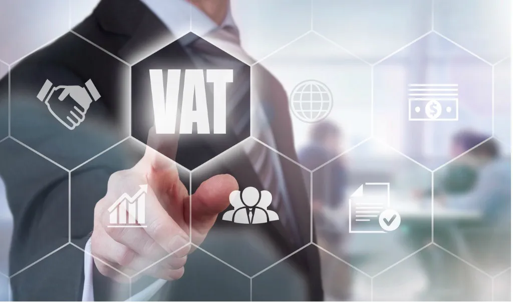 man in suit points at text reading VAT - understanding VAT