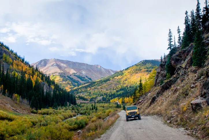 Yellow Jeep on Cinnamon Pass in autumn, Colorado.